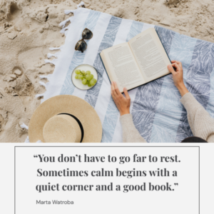 A woman resting on the beach with a book, sunhat, and fruit beside her — symbolising slow summer moments, calm, and everyday micro-rest.