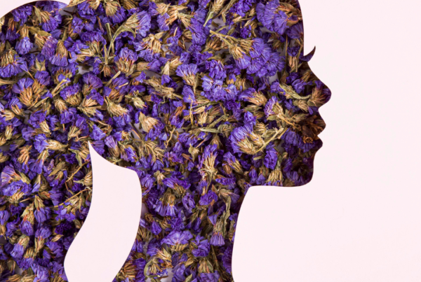 Silhouette of a woman’s head filled with purple flowers symbolising inner thoughts, emotions and mental wellbeing